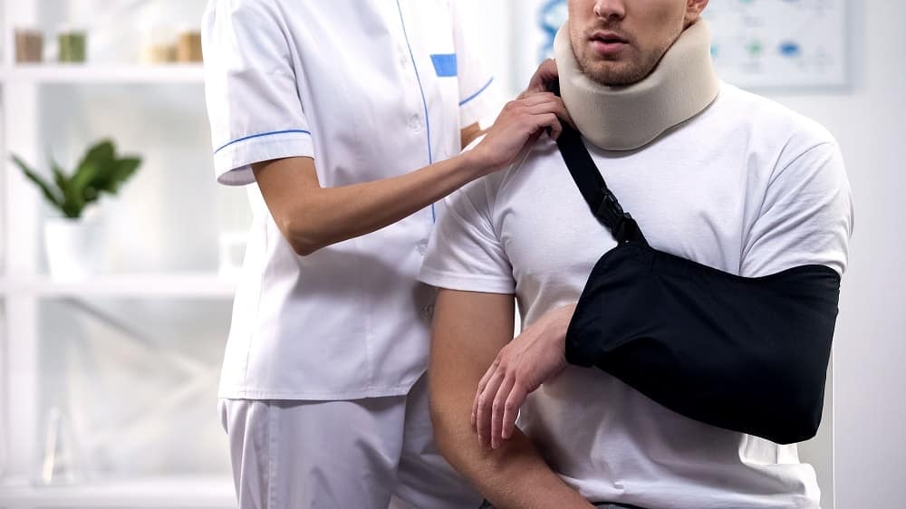 Man receiving medical care after a car accident