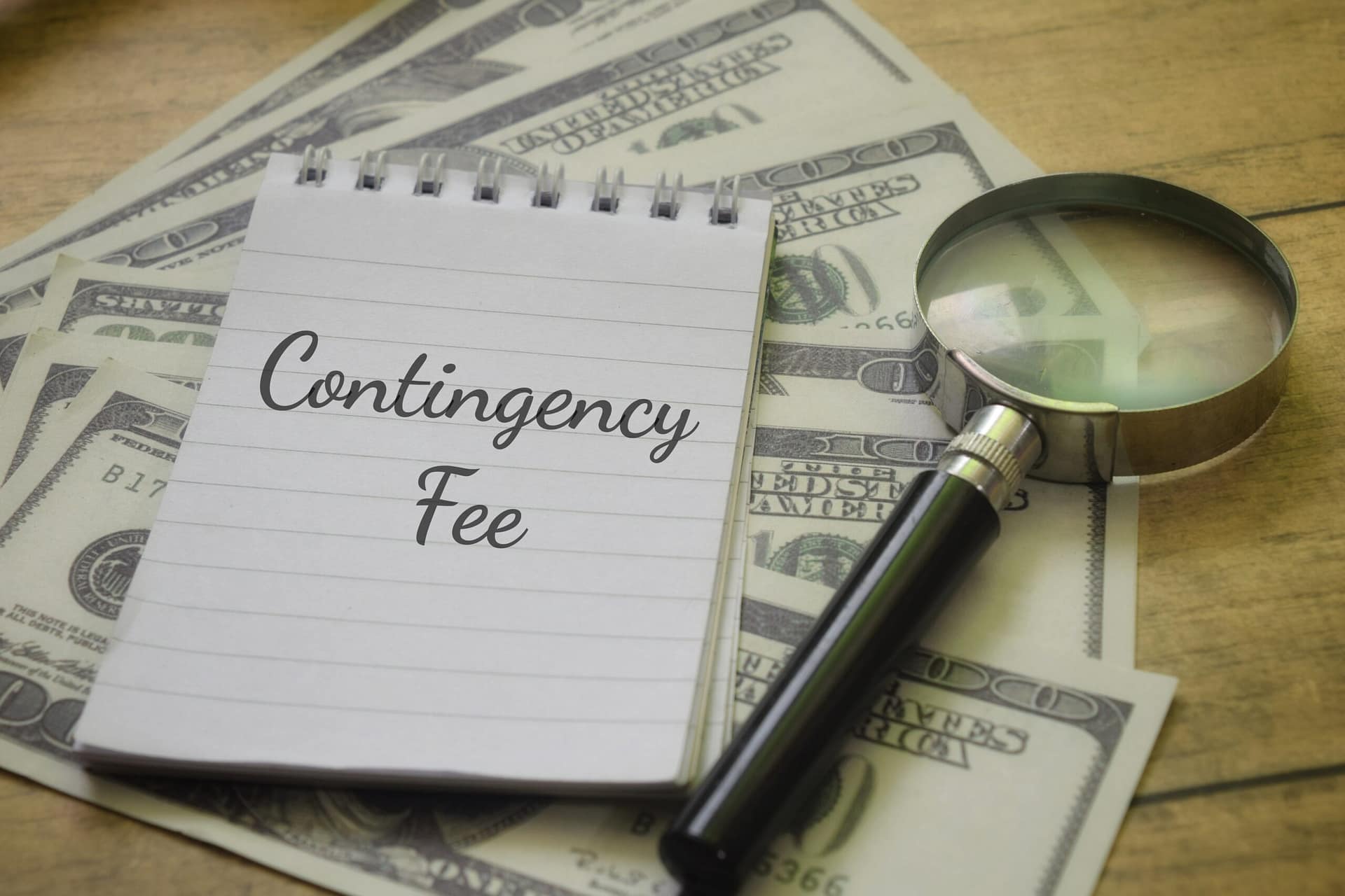 Contingency Fee wording with magnifying glass and money.