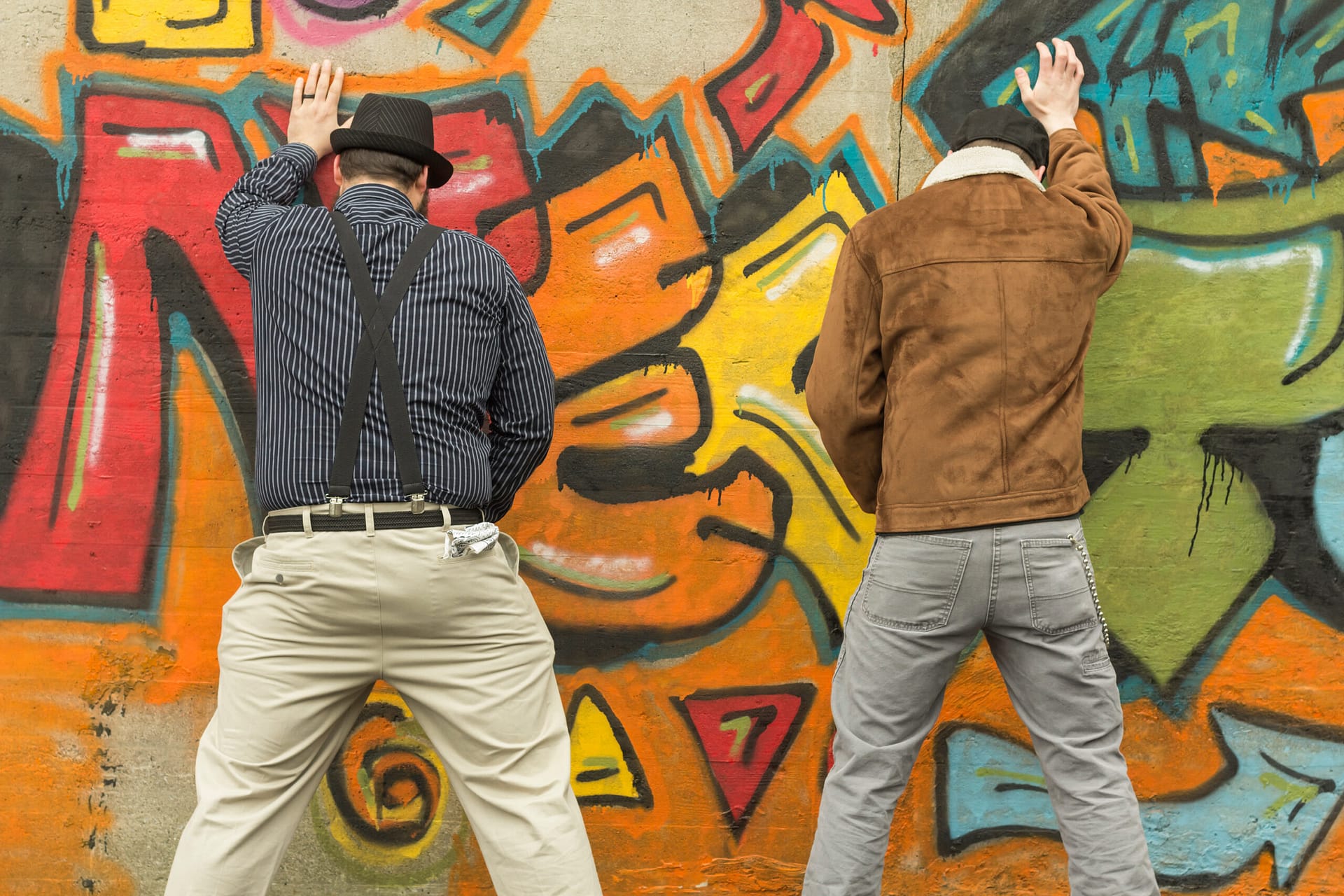 Two snazzy stylish men relieve themselves in public
