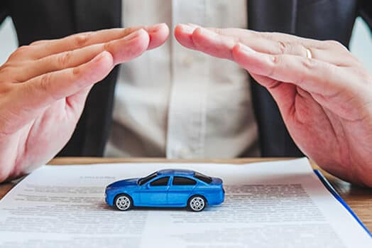 Hands covering a car- Driving without insurance: penalties by state and Texas