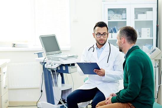 Ver a un médico por lesiones en accidentes de auto 2 Médico hablando con un paciente: médico por lesiones en accidentes de auto en Texas