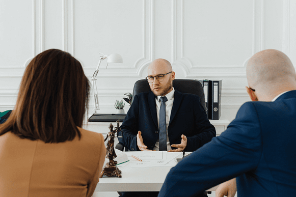 Can a Personal Injury Lawyer Drop Your Case? 2 Personal Injury Lawyer Speaking to Clients About Withdrawing from Their Case