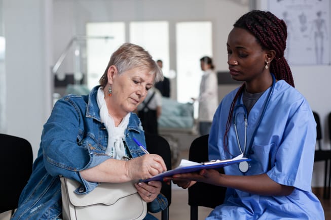 How to Calculate Pain and Suffering Damages in Texas 4 Woman signing medical documents at hospital