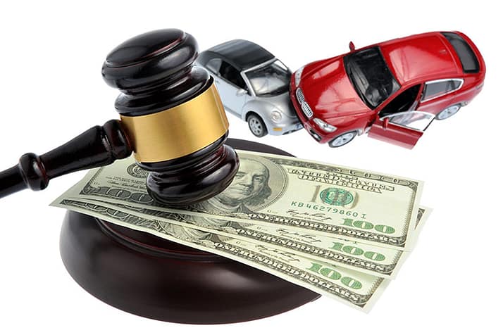 Is Hiring a Lawyer After a Car Accident Worth It? 3 Two toy cars that look like they've been in a wreck next to a gavel on top of 3 hundred dollar bills. Getting a Lawyer for a Car Accident