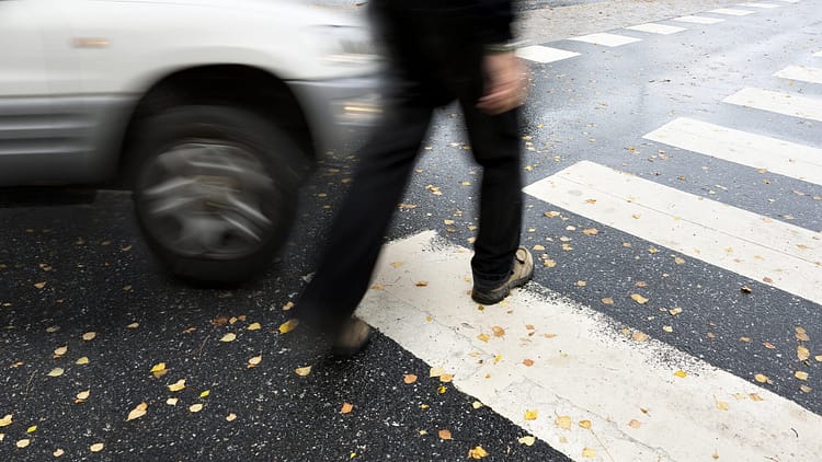 Man walking through a crosswalk about to be hit by a car - Austin Pedestrian Accident Attorneys