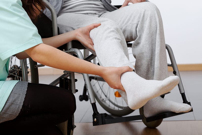 Young physiotherapist exercising with elder disabled person - Lubbock personal injury lawyers