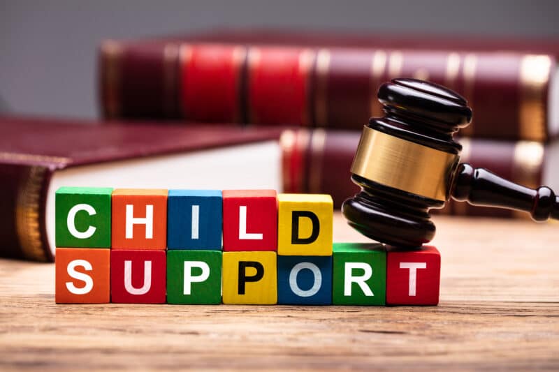 Child Support Block With Bible And Mallet. Child support liens